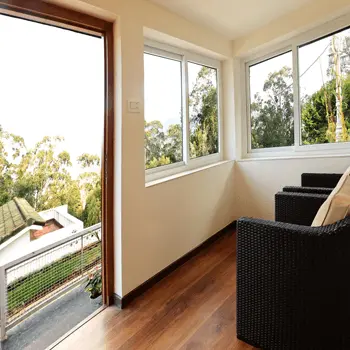 Wood-floored sitting area opening onto a garden balcony