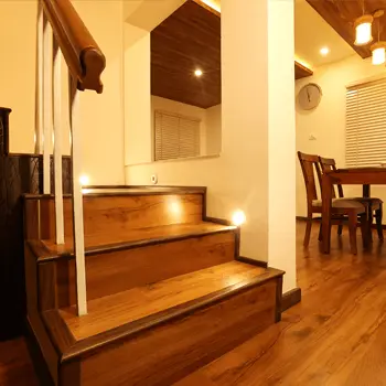 Illuminated wooden steps leading into the dining area