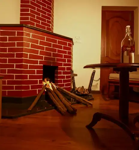 Indoor brick fireplace beside wooden seating