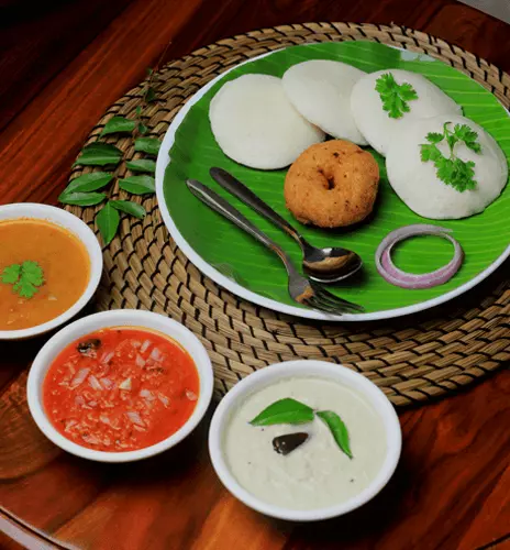 Idli and vada served with chutneys and sambar